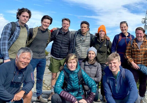 Dean Takahashi with group of students atop mountain