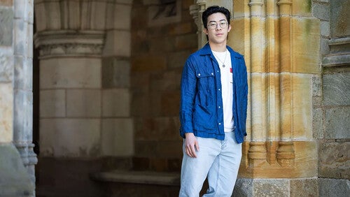 Nathan Chen standing beside building on campus